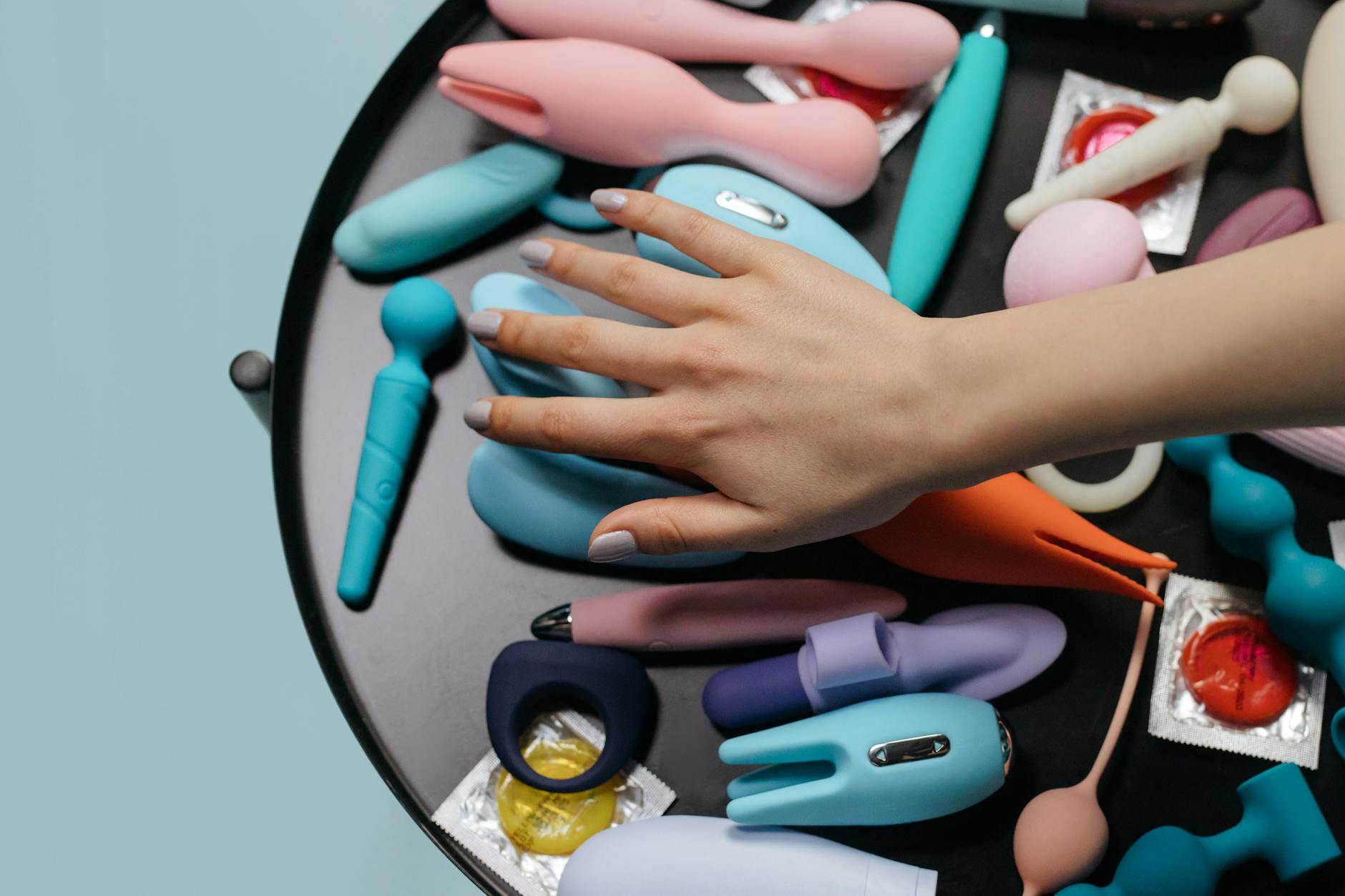 A couple together holding a blue vibrator, representing modern partnered intimacy and shared pleasure