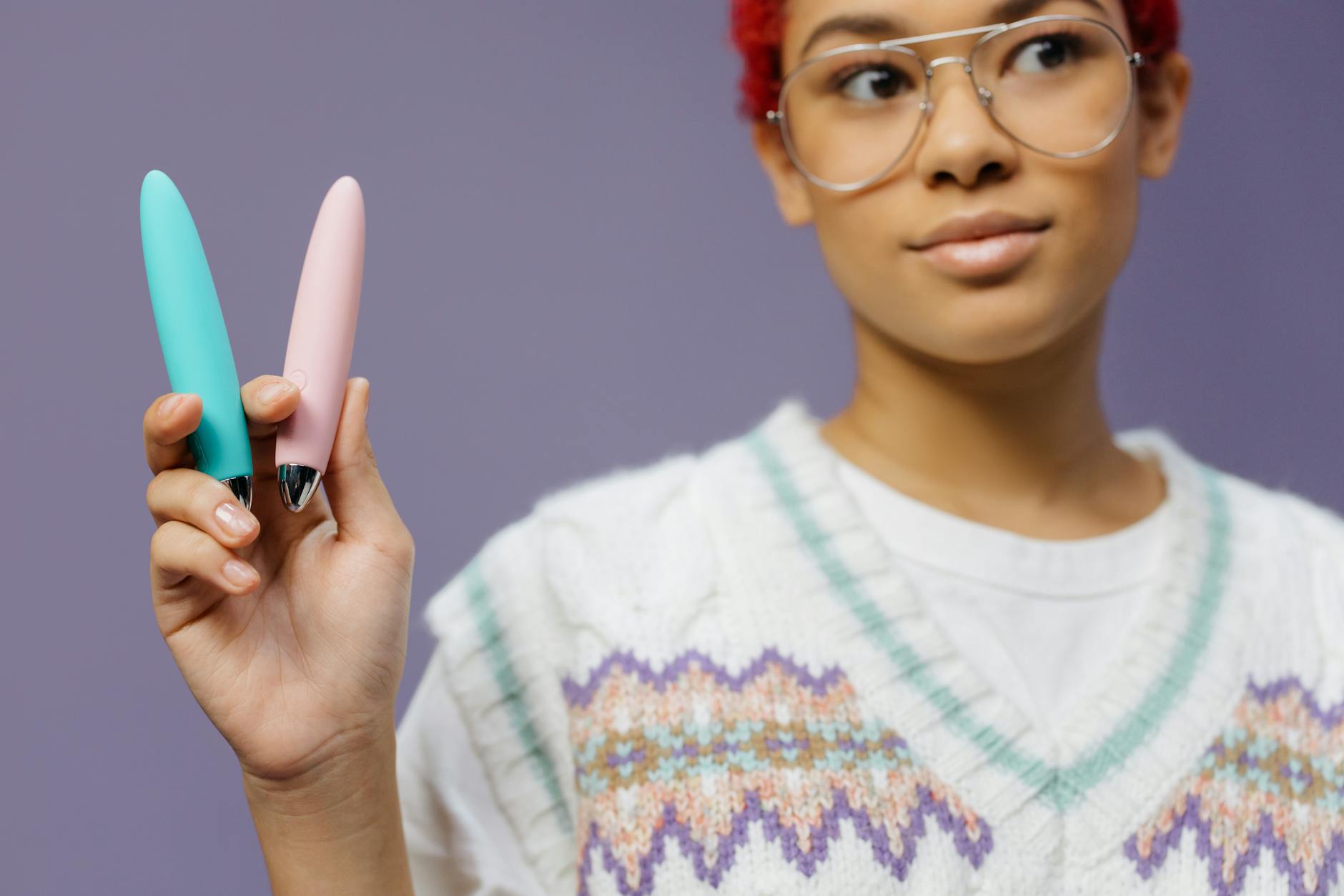 Woman holding colorful vibrators, representing shared exploration and partner intimacy