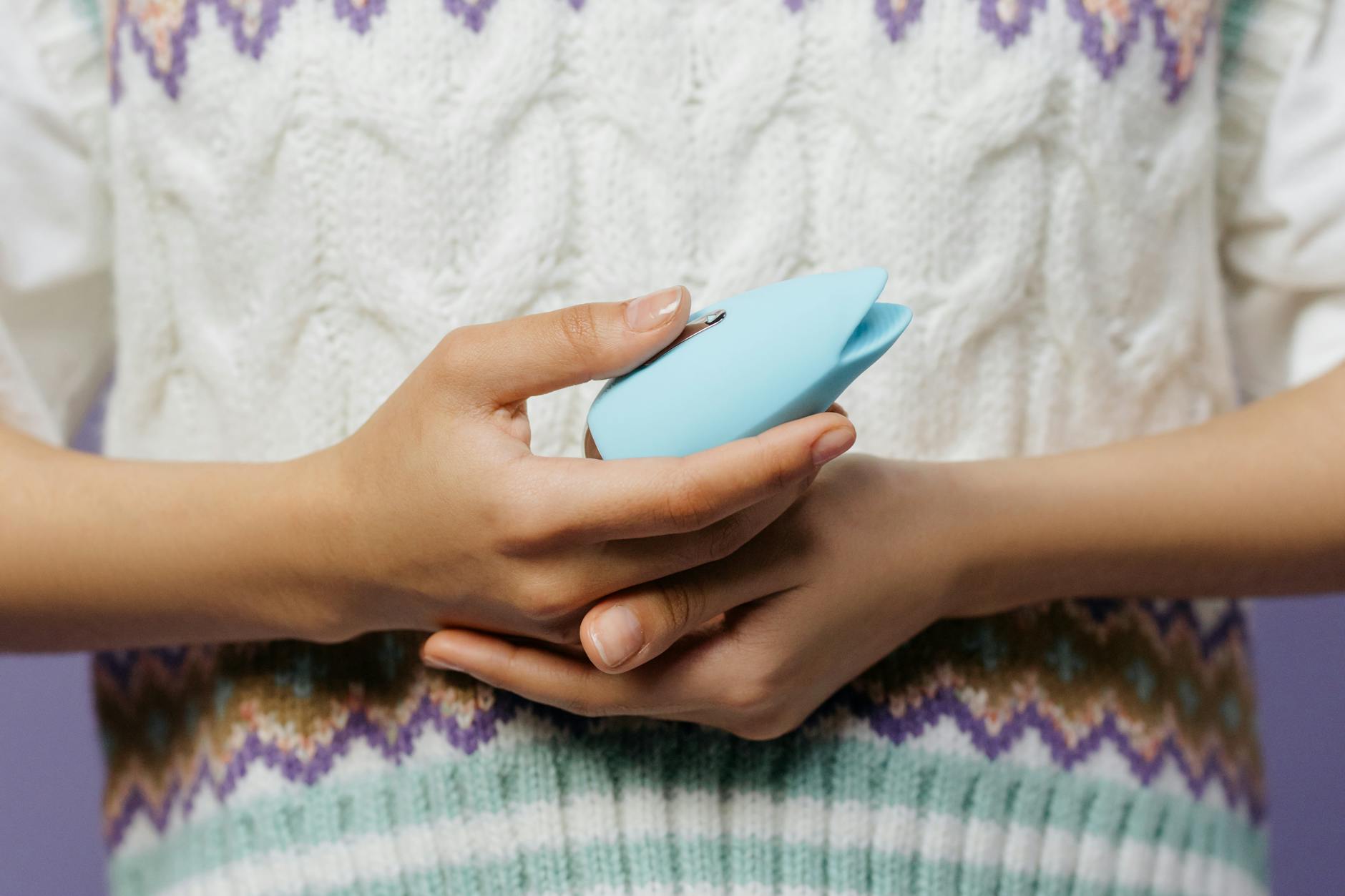 Woman holding lemon vibrators in a thoughtful pose, considering pleasure on her own terms