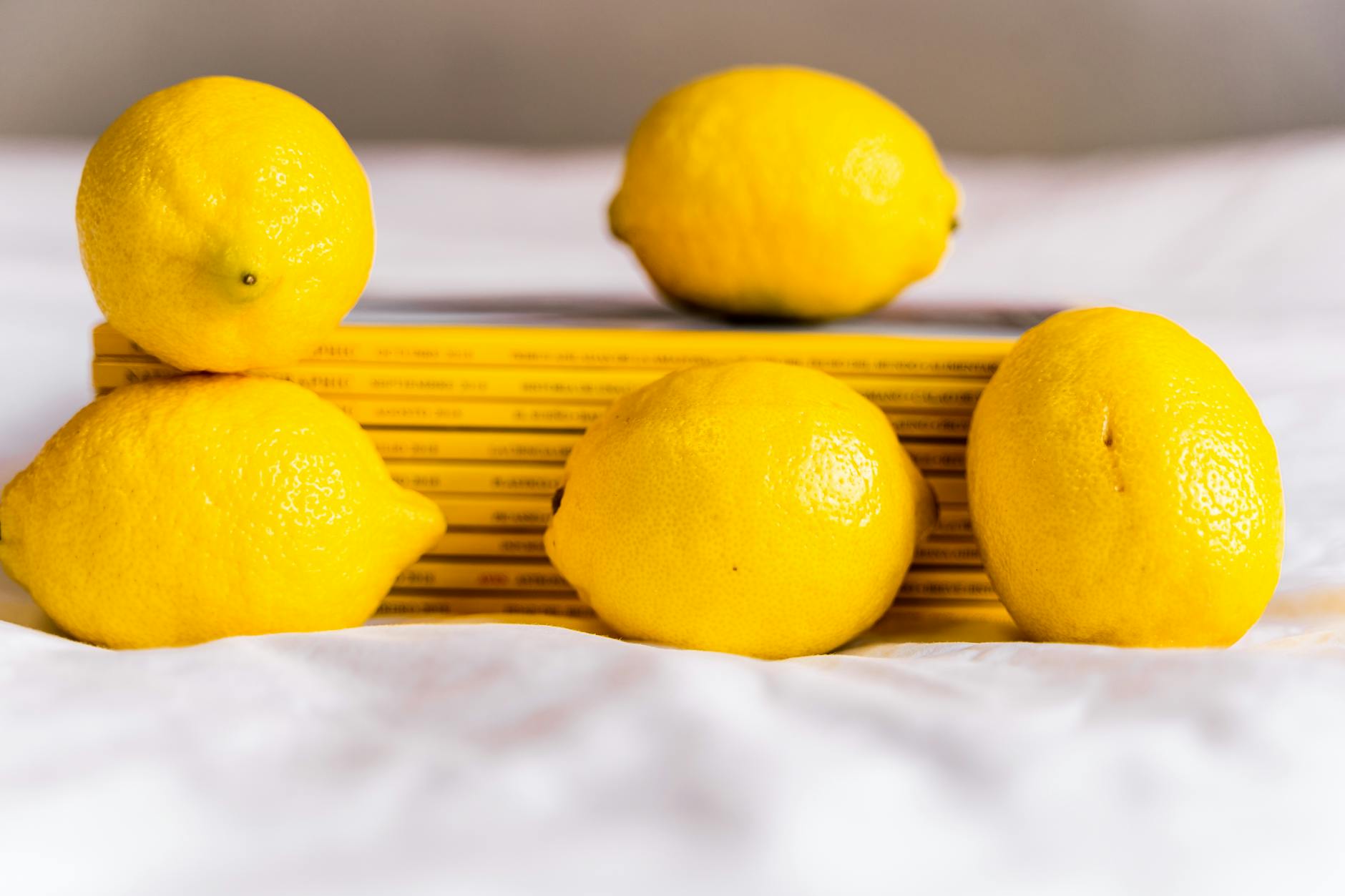 Ripe vivid lemons on a bright yellow background in studio lighting